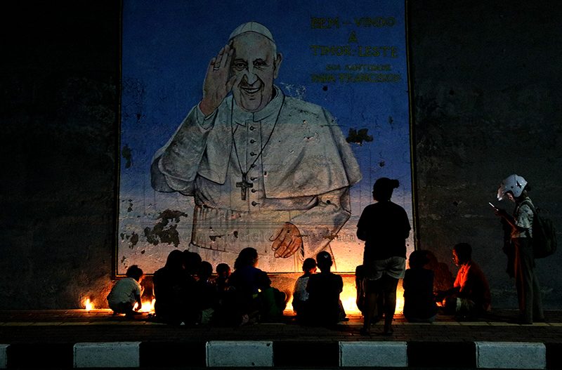 Catholic community in Kovalima places flowers and lights candles at monument of Our Lady